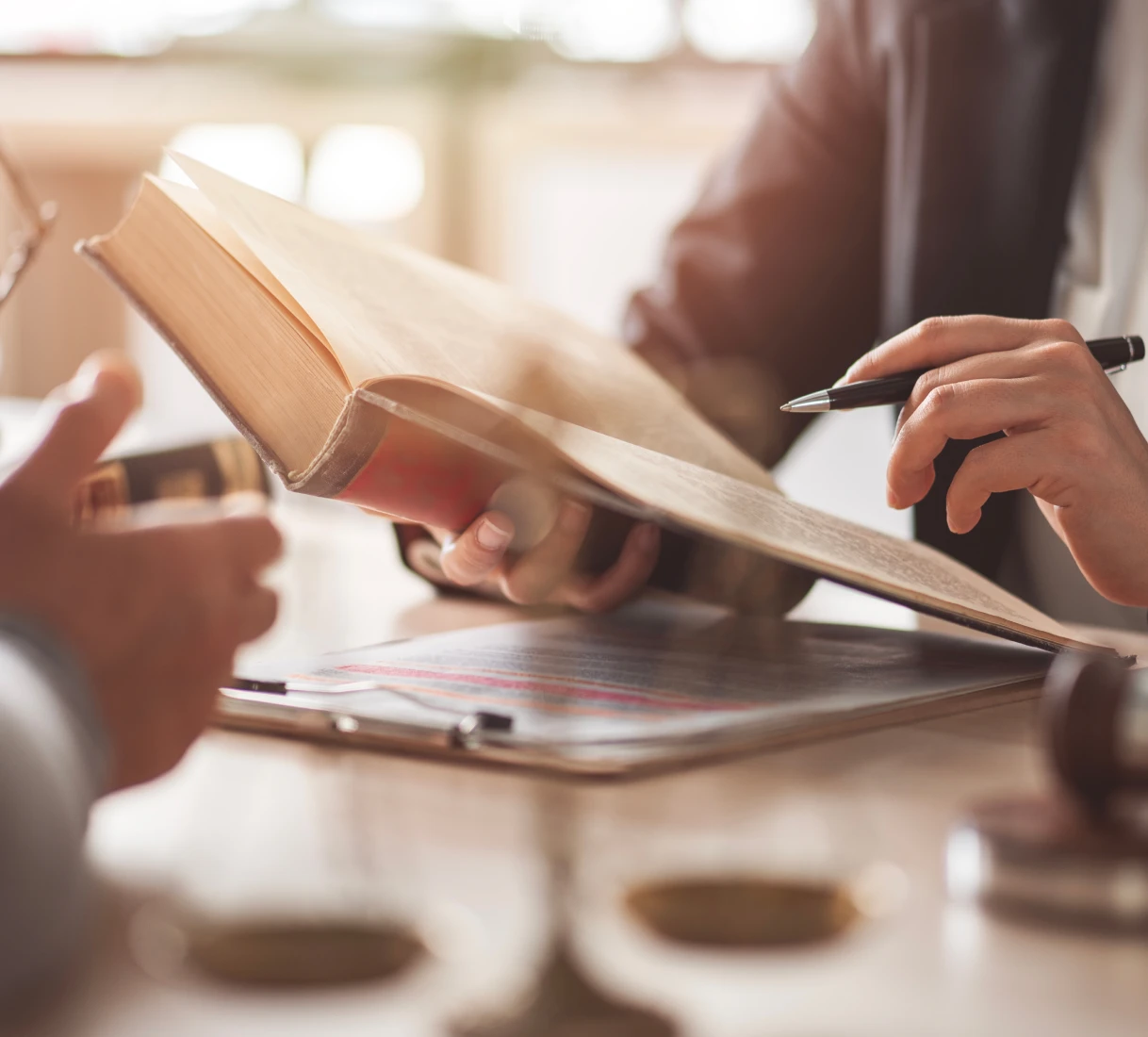 Hands reading a legal book