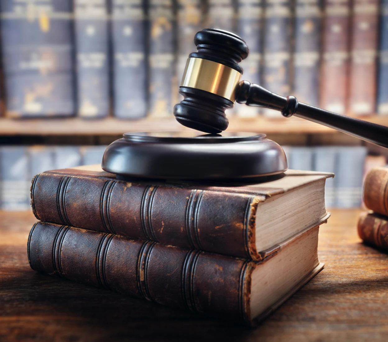 Legal books with a gavel on top