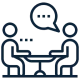 Two people talking at a table icon